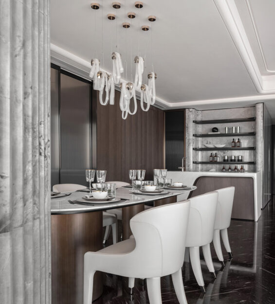 Modern bar & dining design with dark wood cabinetry, marble backsplash, island bar with curved elements. designer dining chair & dining table complimented with luxury bar